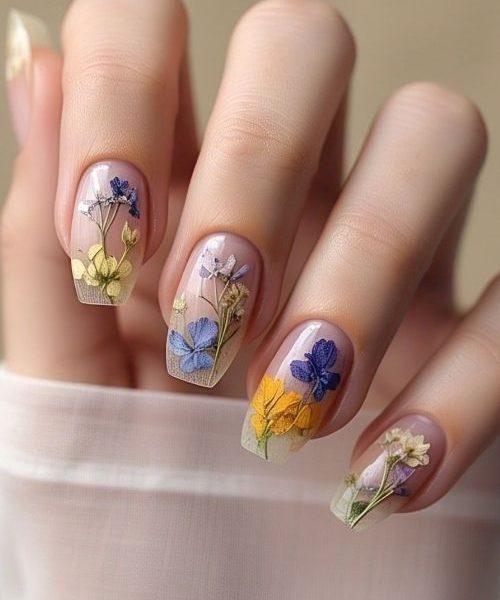 15. A Romantic Hand In Long Sleeves, Featuring March Nails Ideas With Tiny Pressed Flowers Encased In Sheer Polish, Creating A Botanical And Enchanting Nail Look