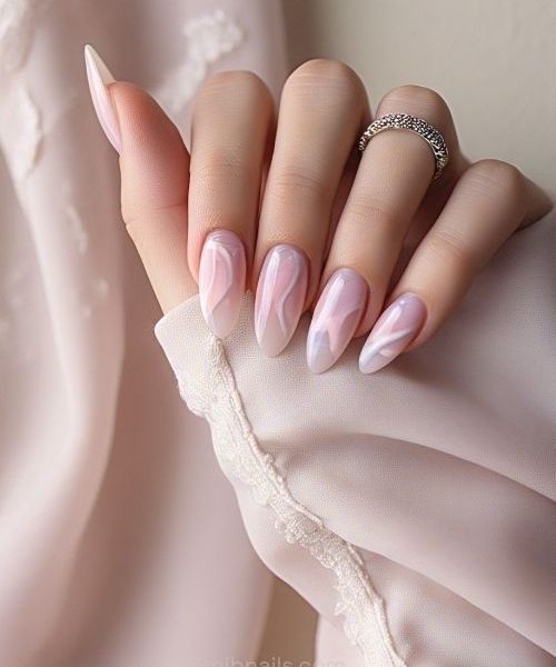 6. Almond Acrylic Nails With Soft Pink And White Rose Quartz Swirls, Paired With One Hand In Romantic Long Sleeves.