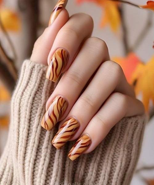 7. Spicy Warm Cinnamon Swirl Fall Nails On One Hand, Adding Flair To Long Sleeves