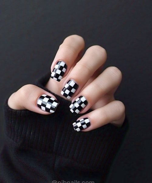 9. Bold Checkerboard Gel Nails For Short Nails On A Single Hand, Paired With Modern Long Sleeves